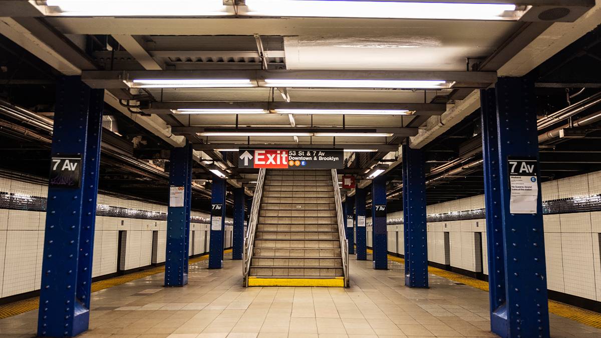 subway platform with signs in NYC